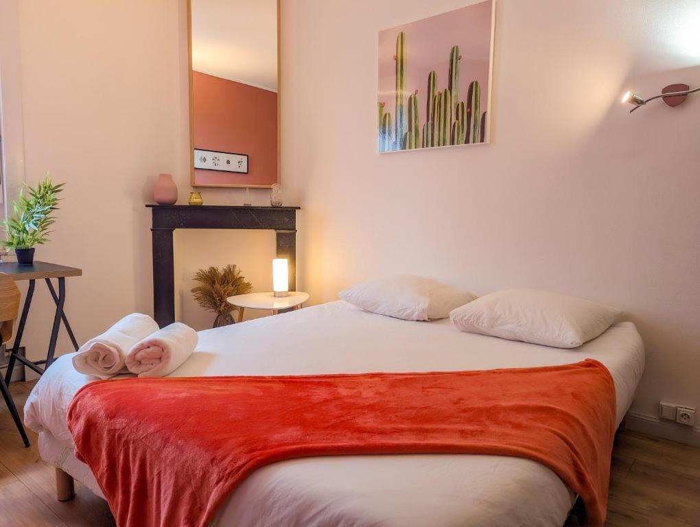 - une chambre avec un lit et 2 serviettes dans l'établissement Le Cocon Bleu - Appartement Calme - Parking Gratuit - Fibre, à Arras