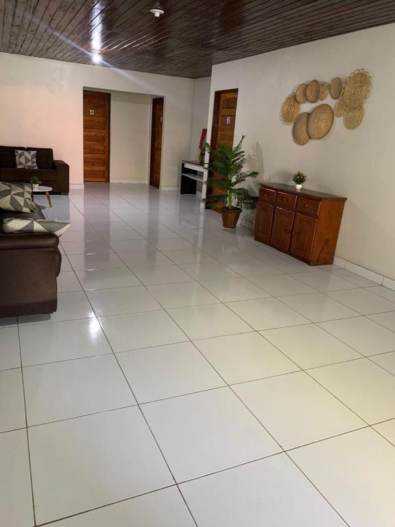 a large room with a large white tile floor at Pousada Caminho do Paraiso in Maragogi