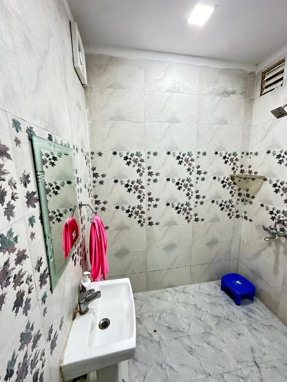 a bathroom with a sink and a mirror at MB farms in Greater Noida
