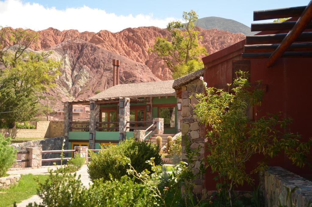 a building with a mountain in the background at El Refugio de Coquena in Purmamarca