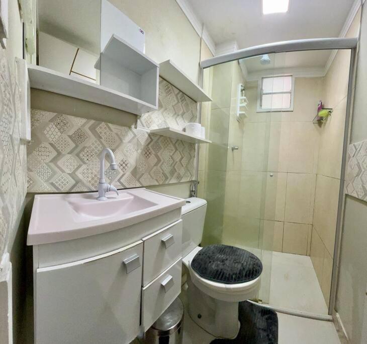 a bathroom with a toilet and a sink and a shower at Apartamento Charmie in São Luís