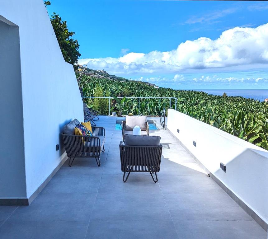 a patio with two chairs and a table on a balcony at La Palma Luxury Heritage in Las Ledas
