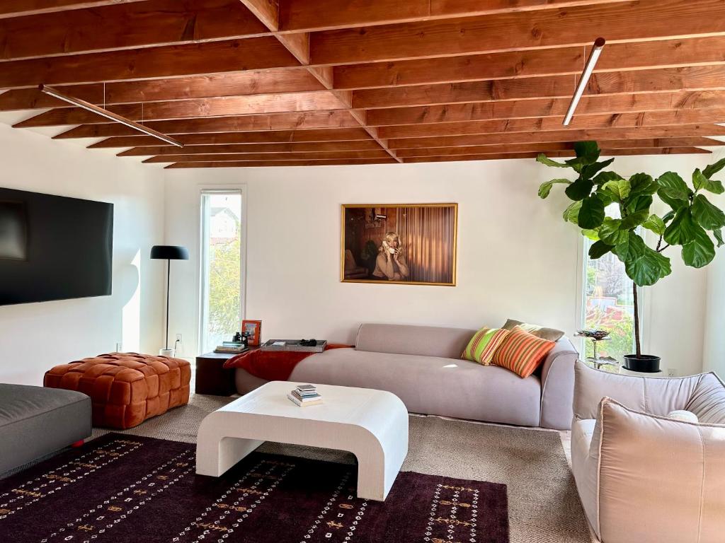 a living room with a couch and a table at Spacious Resort Getaway @ Echo Park Ranch - Luxury indoor/ outdoor home steps from Sunset Blvd, Echo Park Lake, Dodgers Stadium in Los Angeles