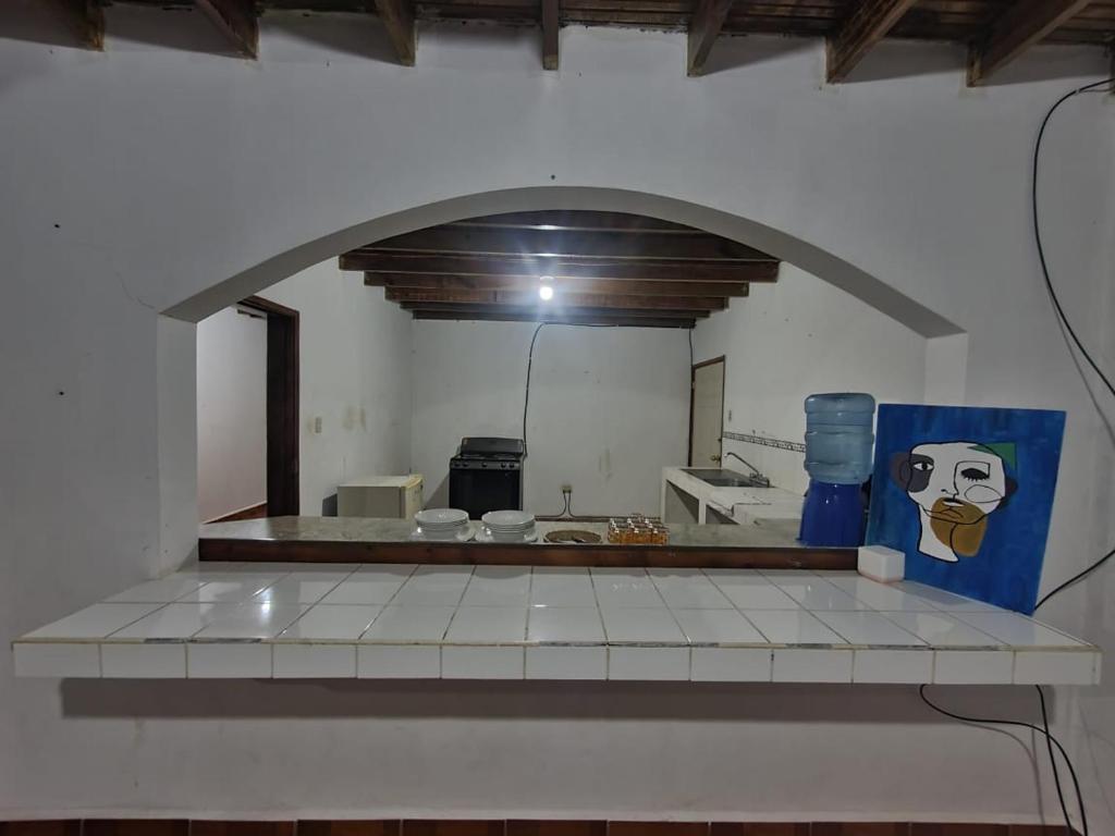 a view of a kitchen with an archway at Casa Rincón Ojojona in Media Legua
