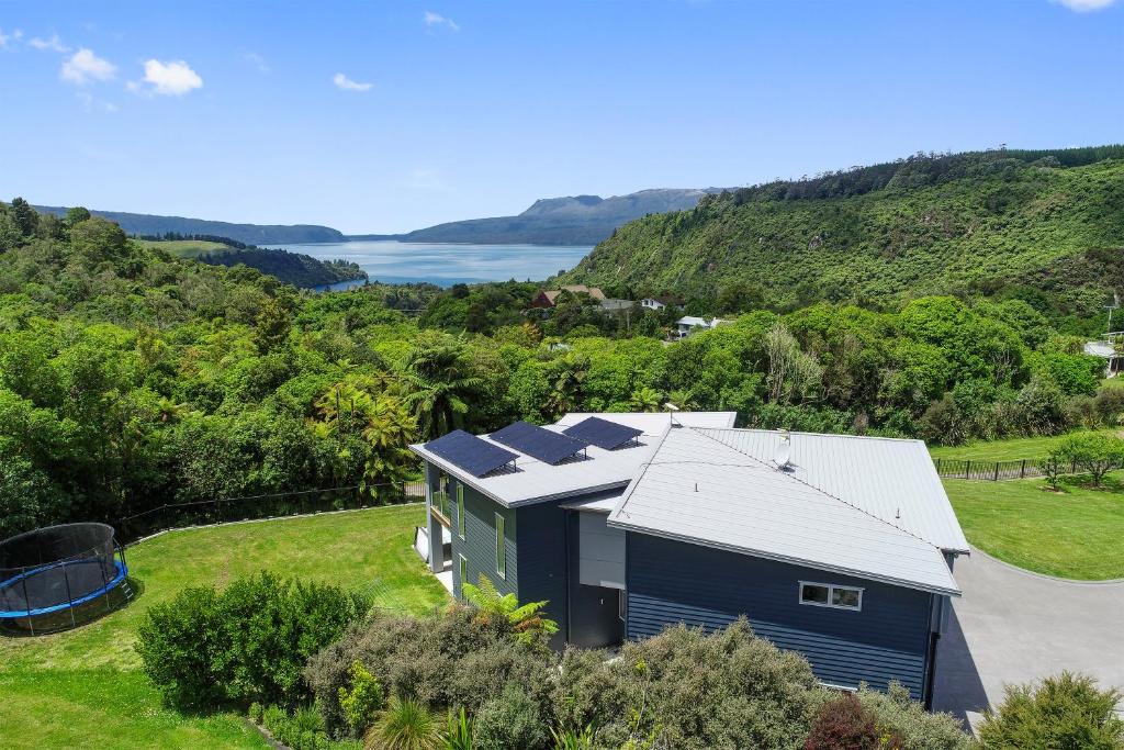an aerial view of a blue house with solar panels on it at Tarawera Paradise in Rotorua