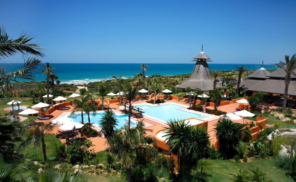 uma vista aérea de um resort com piscina e oceano em Royal Hideaway Sancti Petri em Chiclana de la Frontera