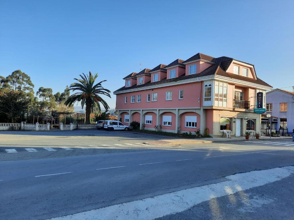 a large pink building on the side of a street at Hotel Pedramea in A Coruña