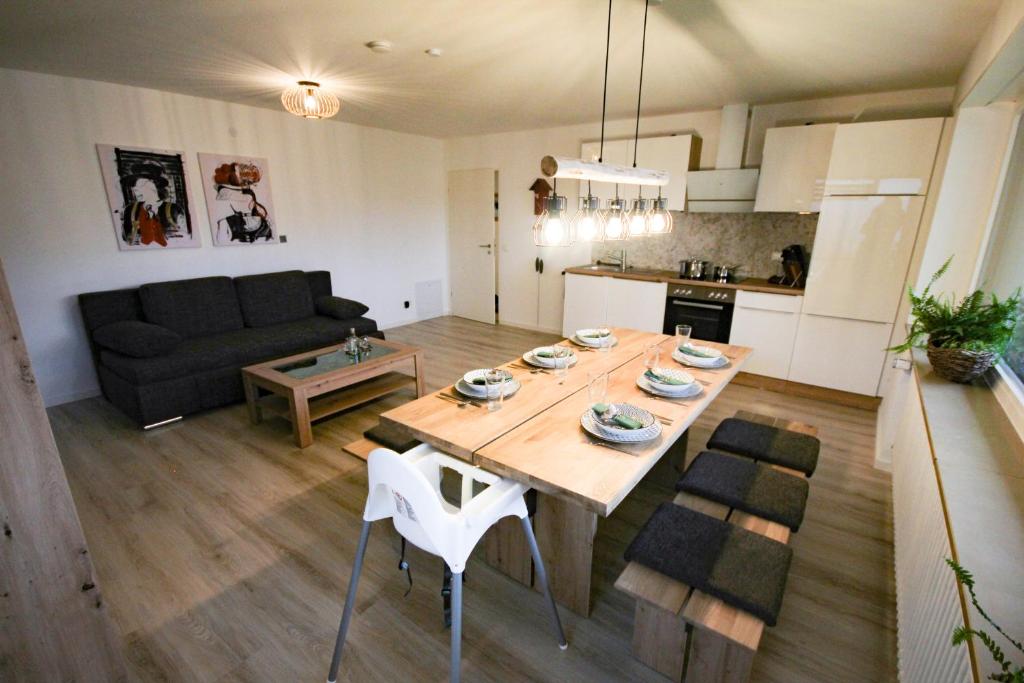 a kitchen and a living room with a table and a couch at Spechthöhle - St. Georgen in Sankt Georgen im Schwarzwald