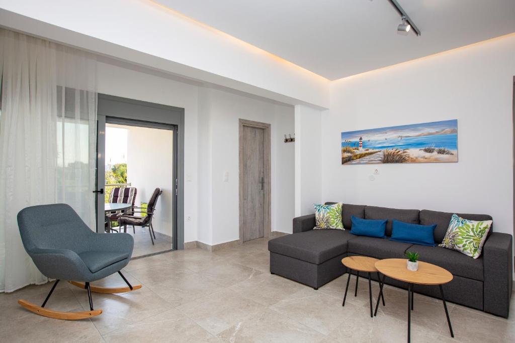 a living room with a couch and a table at SoL Apt Faliraki in Faliraki