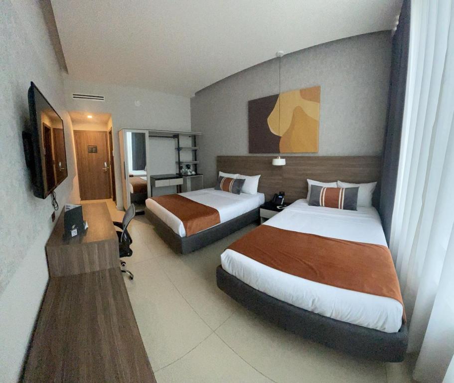 Postel nebo postele na pokoji v ubytování Grand Hotel&Casino Vía Dorada