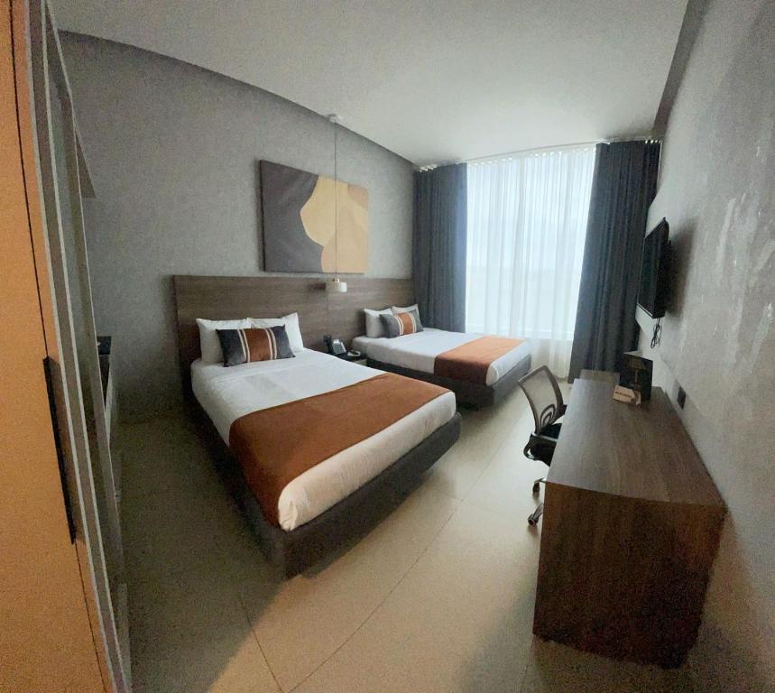 Postel nebo postele na pokoji v ubytování Grand Hotel&Casino Vía Dorada