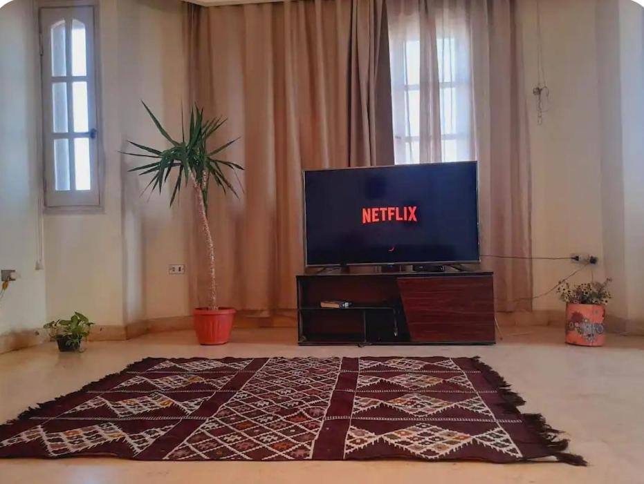a living room with a television and a rug at house in Maadi Degla in Cairo