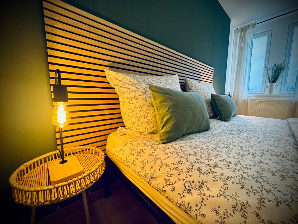 a bedroom with a bed with a wooden head board at One Apartment‘s / Steinweg / Neu in Coburg