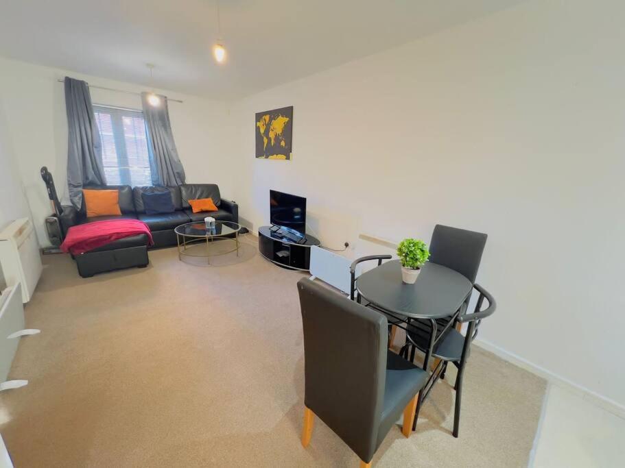 a living room with a table and a couch at Starview Apartment-Vitoria in Lexden