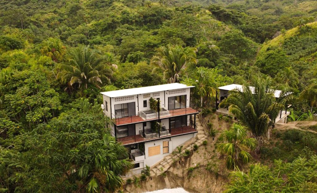 a house on the side of a mountain at Casa Xue Tayrona - Alma Hotels in Los Naranjos