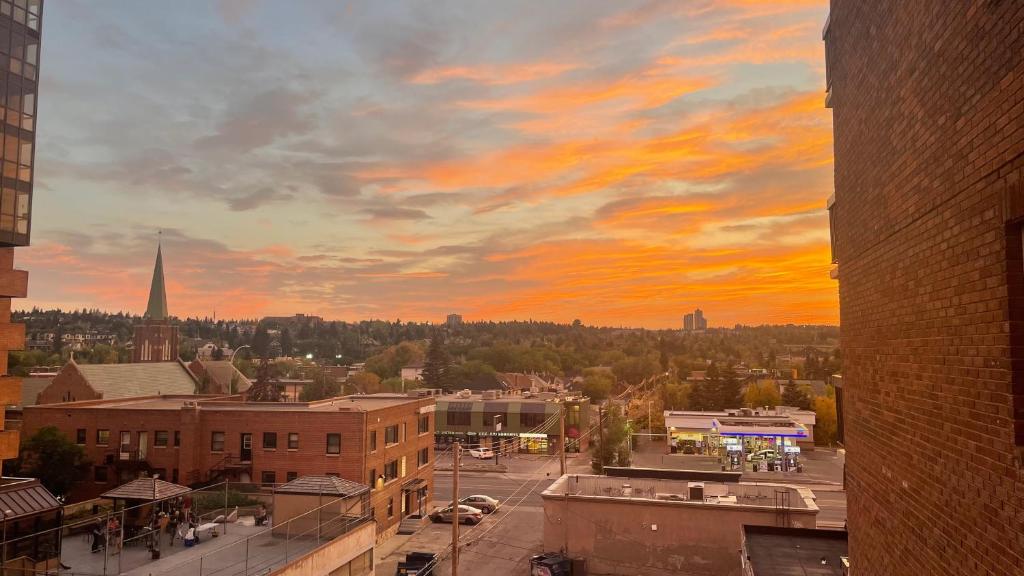 a view of a city skyline with a sunset at Cosy Private Room in Downtown with Free Parking - Self entrance in Calgary