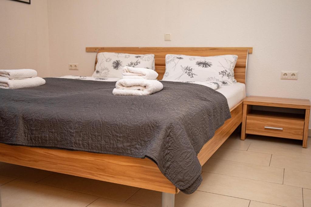 a bedroom with a bed with towels on it at Ferienwohnungen Saida Wohnung 9 in Norden
