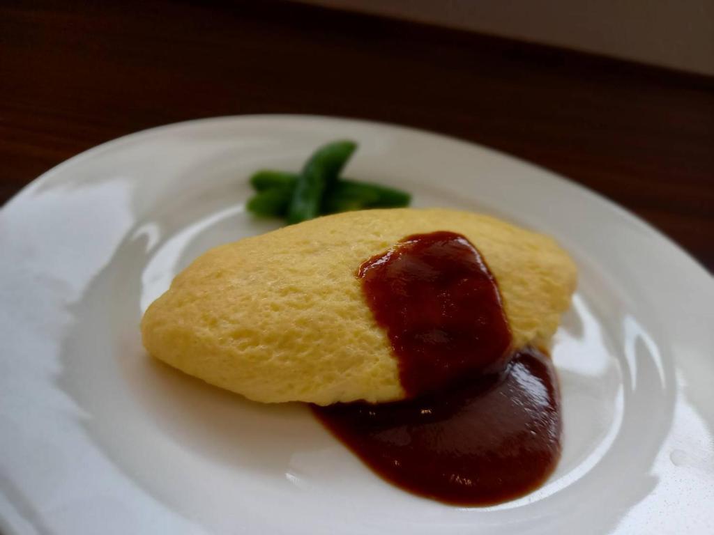 a dessert on a white plate with sauce at Dormy Inn Akihabara in Tokyo