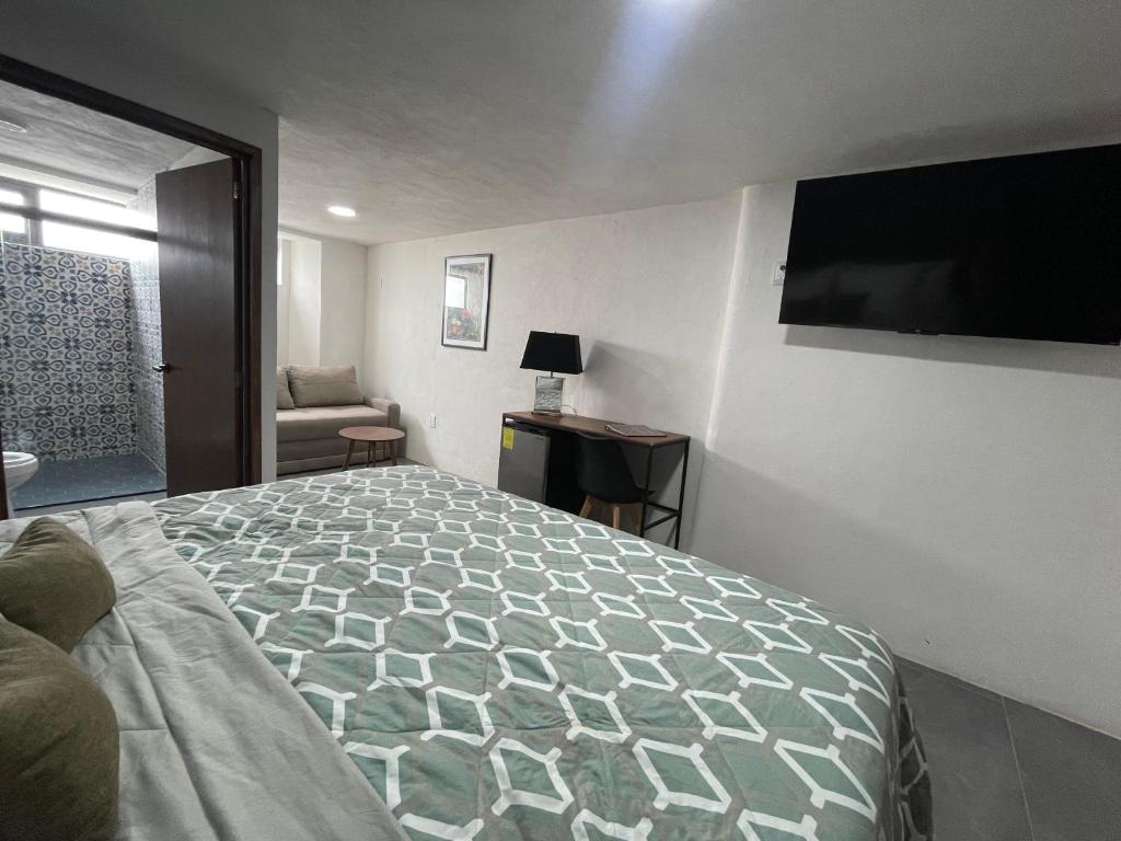 Schlafzimmer mit einem Bett und einem Flachbild-TV in der Unterkunft Quinta La Perla in Guadalajara