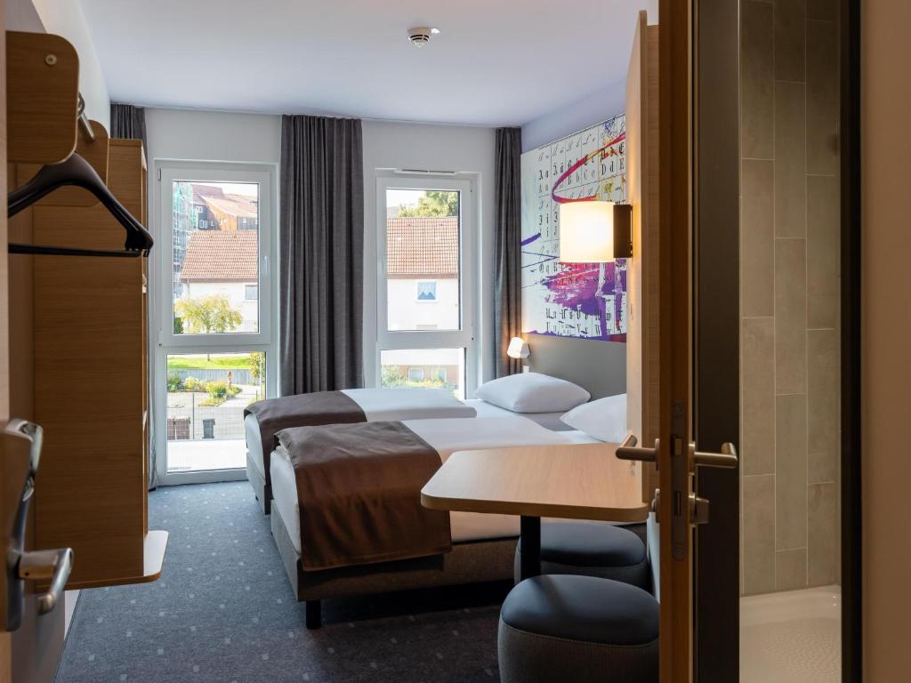 Postel nebo postele na pokoji v ubytování B&B HOTEL Bad Hersfeld