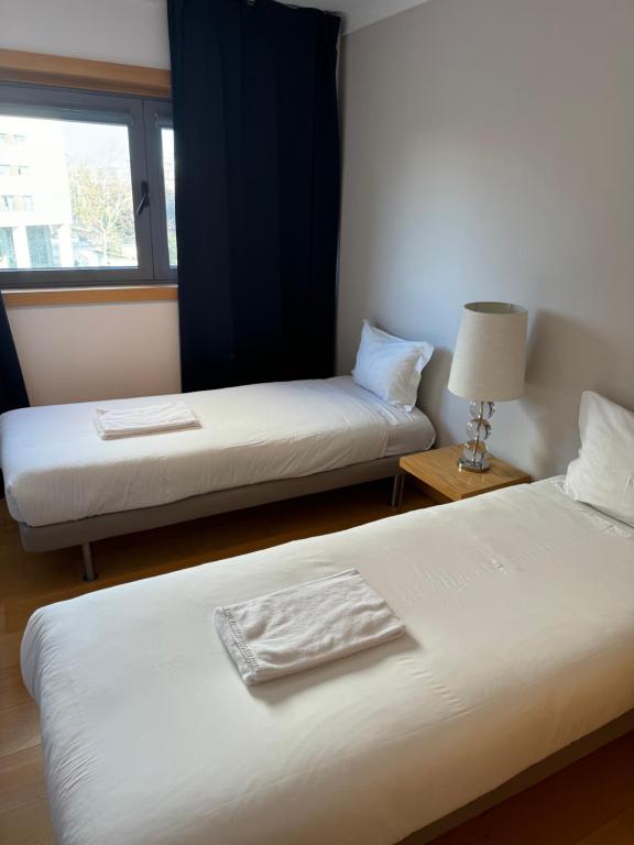 a hotel room with two beds and a window at Expo 53 in Lisbon