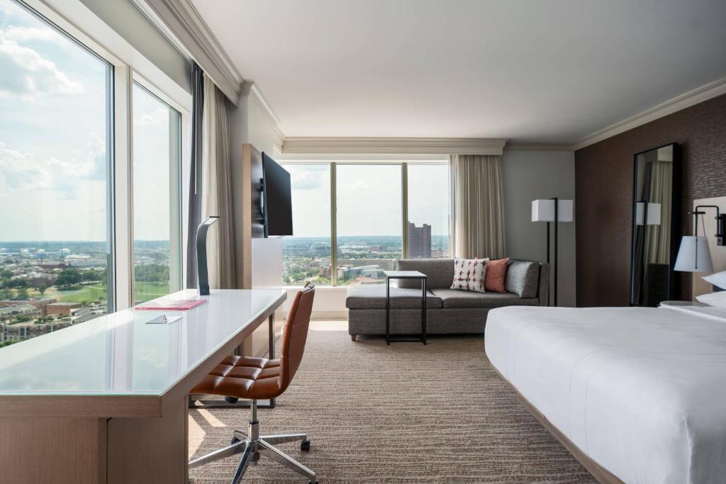 a hotel room with a bed and a desk and a couch at Baltimore Marriott Waterfront in Baltimore