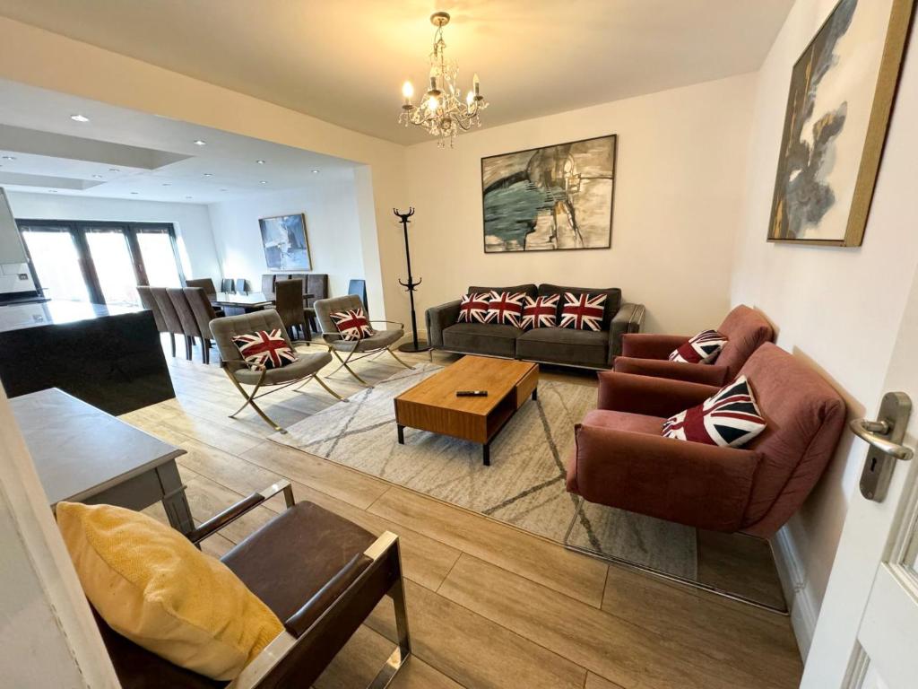 a living room with a couch and chairs and a table at Beahive house in Redbridge