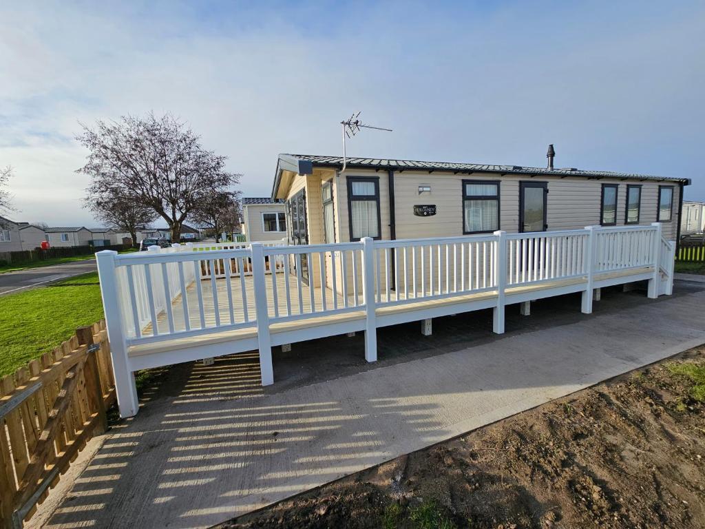 a white fence in front of a house at 208 Holiday Resort Unity Brean 3 bed entertainment passes included in Brean