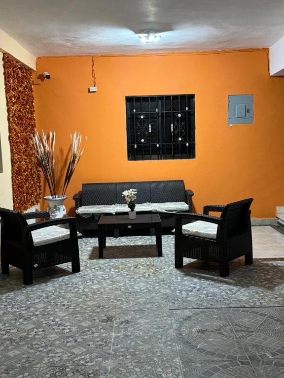 a living room with a couch and a table at Neo’s hotel in Santa Cruz de Barahona