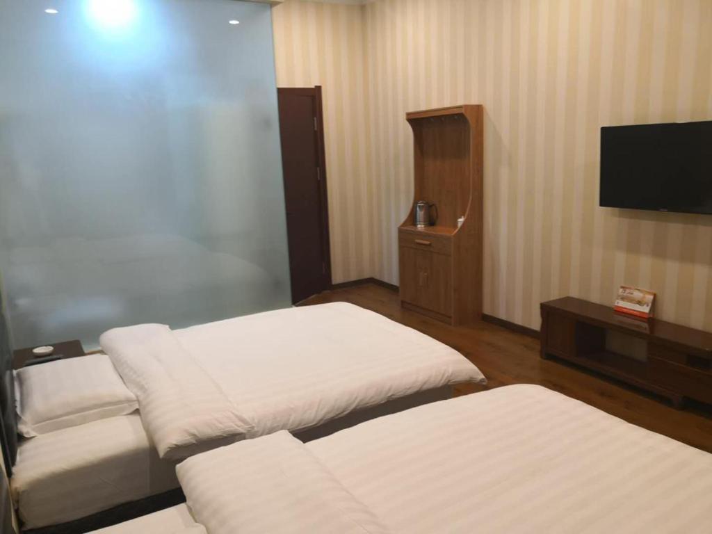 Postel nebo postele na pokoji v ubytování Harbin Binpeng Inn - Harbin Taiping International Airport
