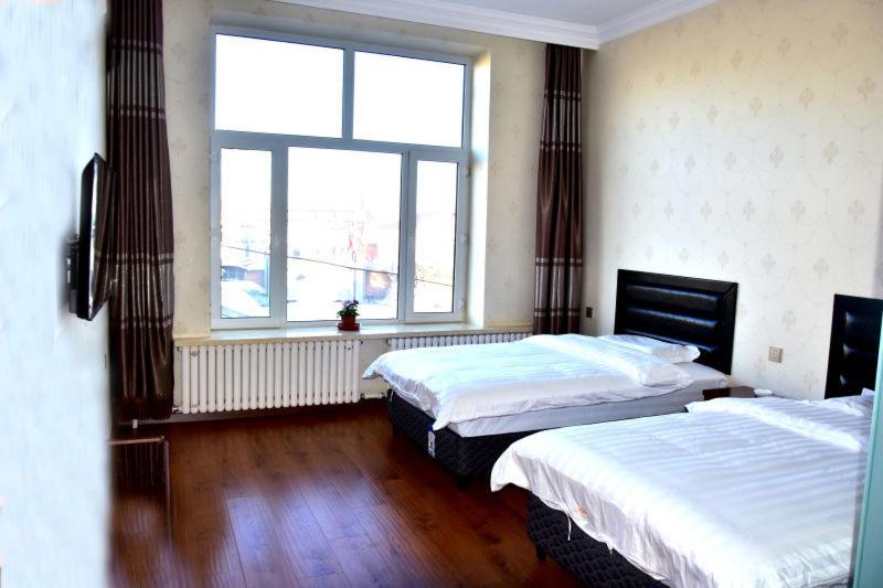 Postel nebo postele na pokoji v ubytování Harbin Binpeng Inn - Harbin Taiping International Airport