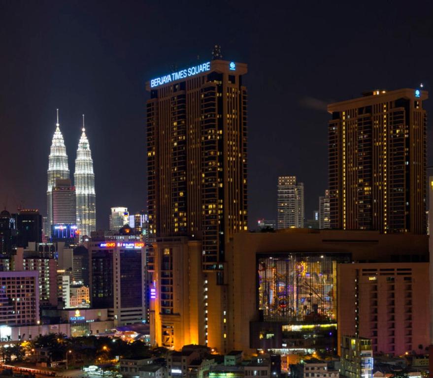 a night view of a city with tall buildings at Bunga Suite at Times Square in Kuala Lumpur