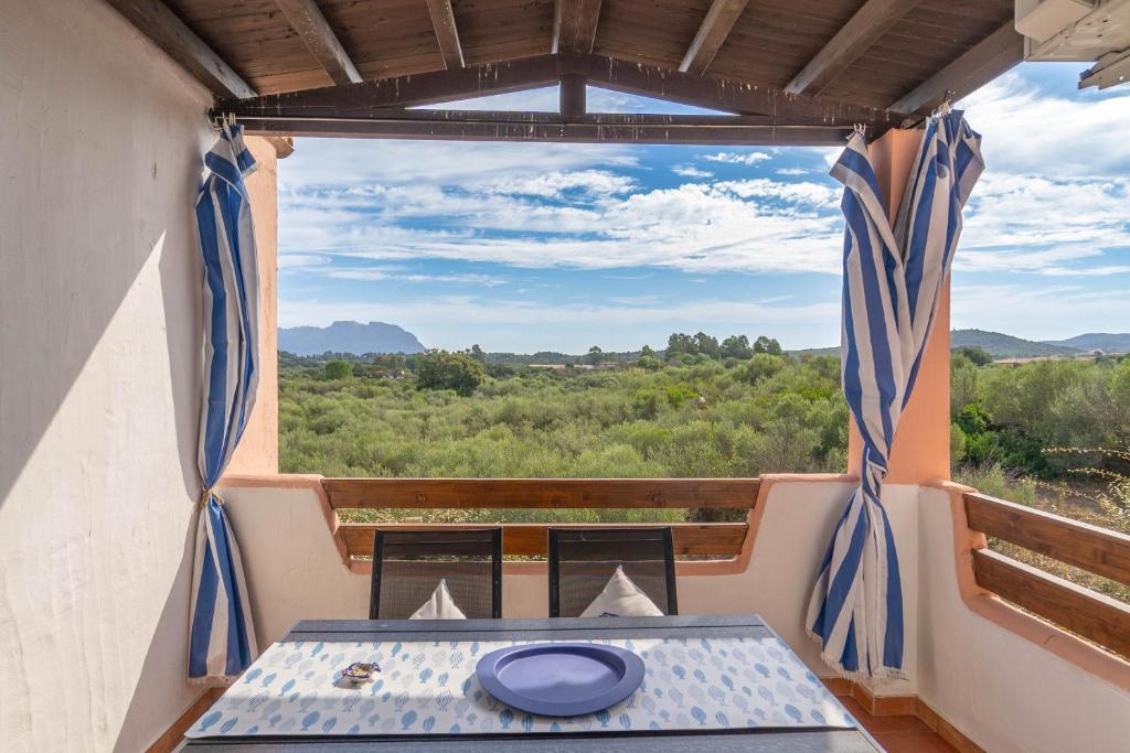 a room with a table and a view from a window at Voilier 28 by DomusAway in Olbia