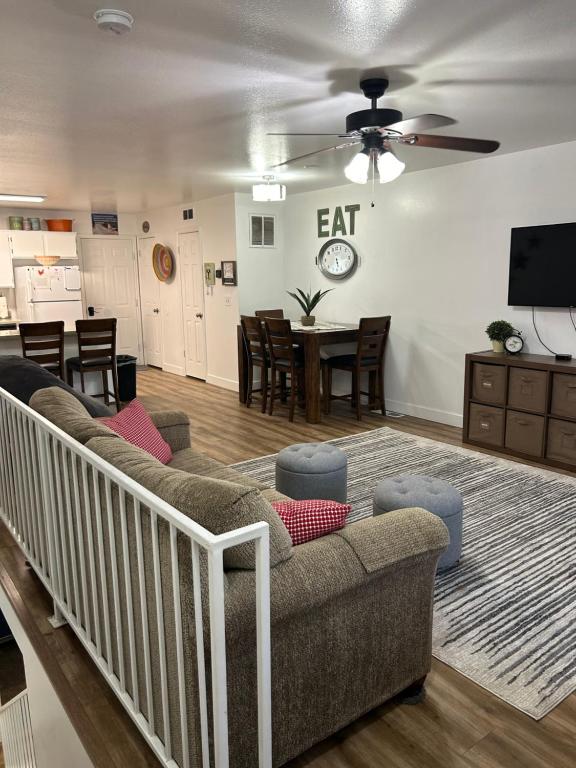 a living room with a couch and a dining room at Red Hen Rental - 2 bed with 1 FULL bath 1 HALF bath FULL Kitchen in Cedar City