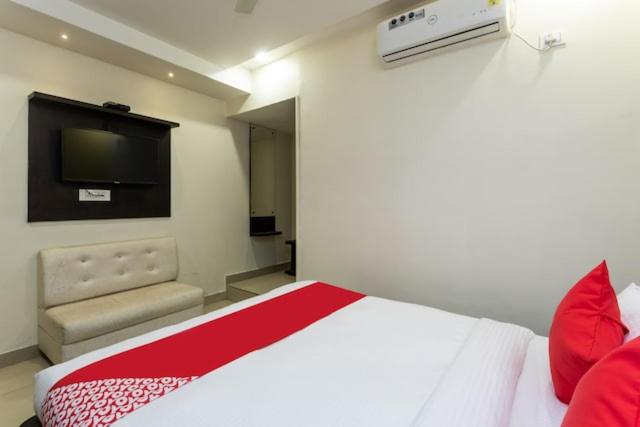 a bedroom with a large bed and a television at Hotel Trishla in Bhopal
