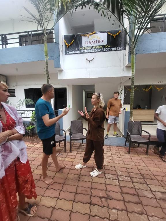a group of people standing in front of a building at hotel ramdev in Arambol