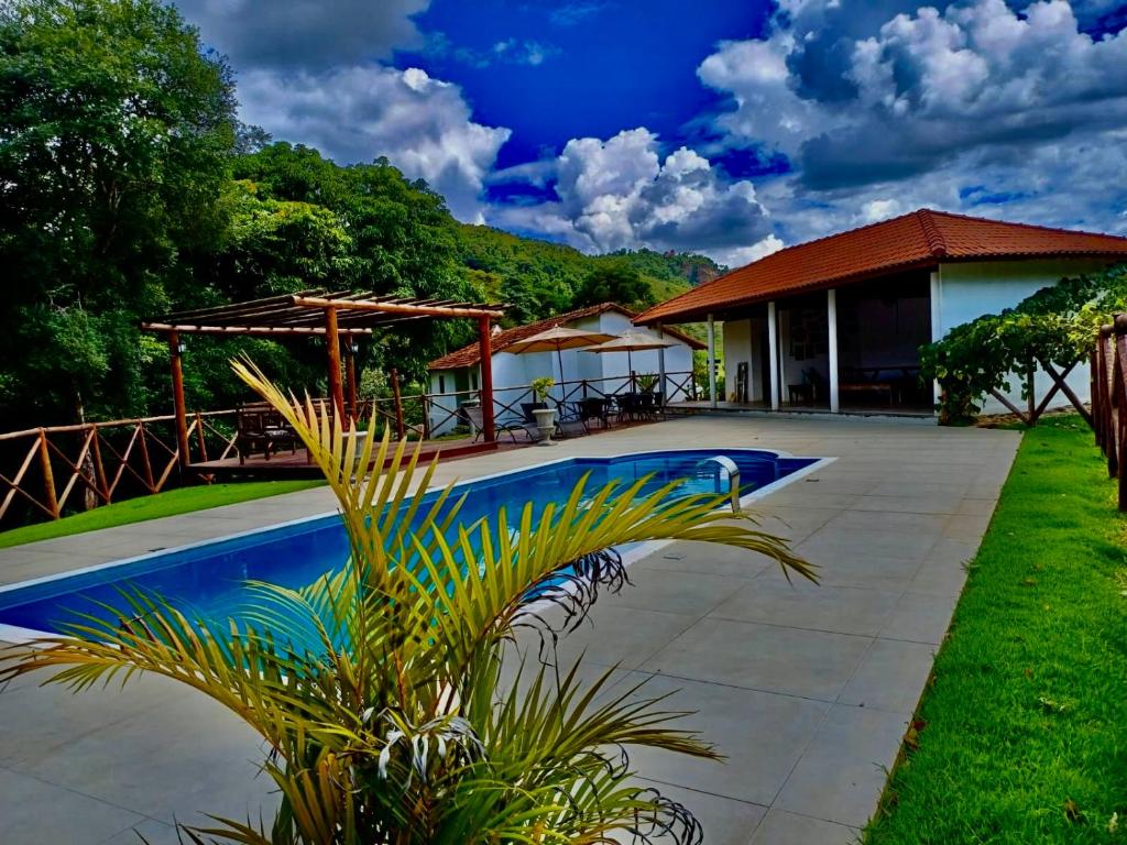 a resort with a swimming pool and a house at Casa Baldoni - Fazenda de Café in Santa Rita do Sapucaí