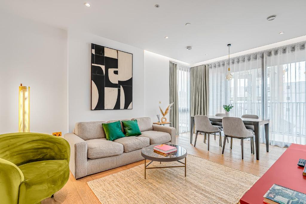 a living room with a couch and a table at Modern King's Cross Apartments in London