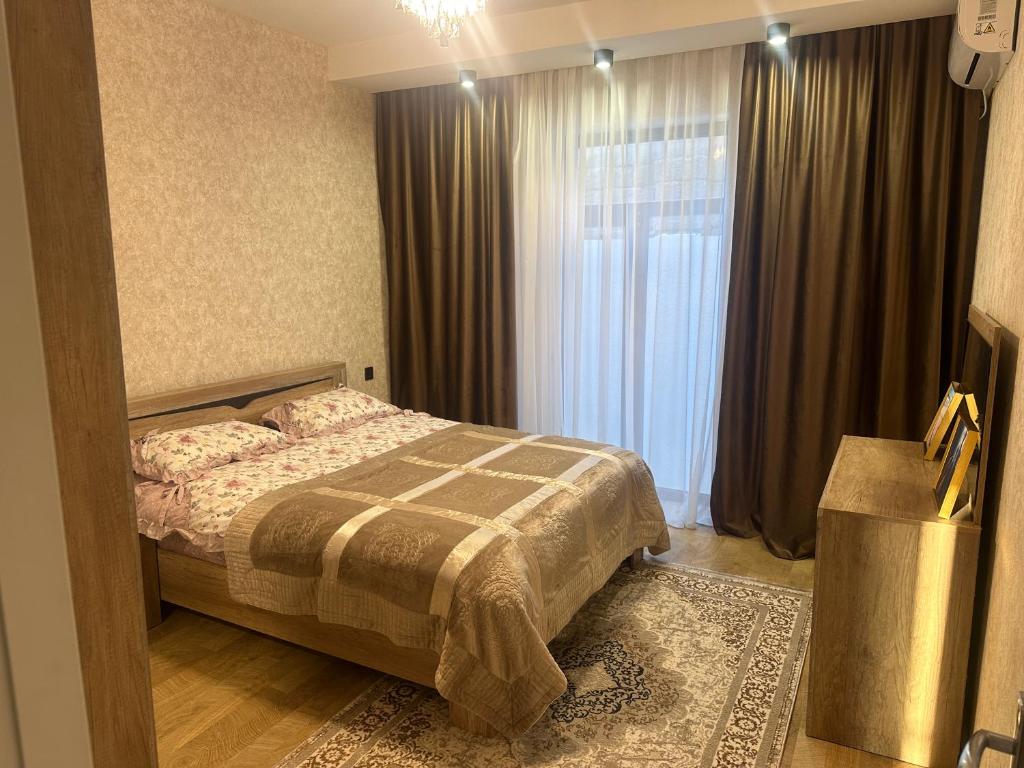 a bedroom with a bed and a large window at Дом у моря Мардакане in Mardakan