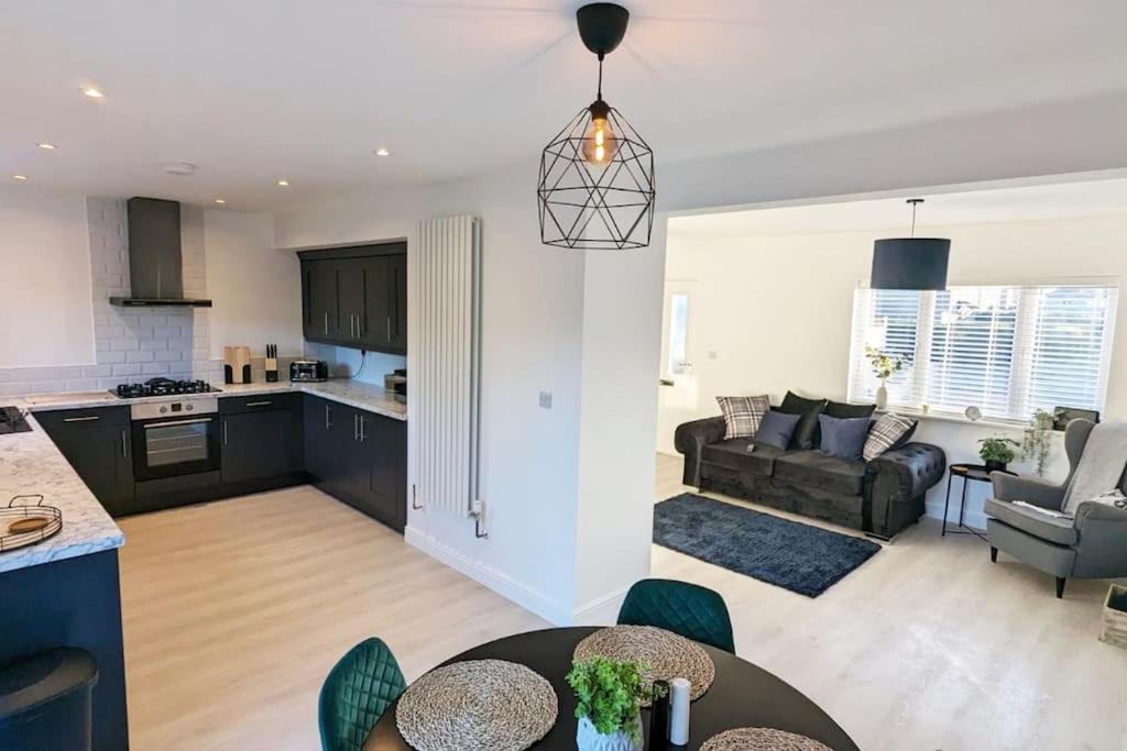 a kitchen and a living room with a table at Gilliver House in Newbold Verdon