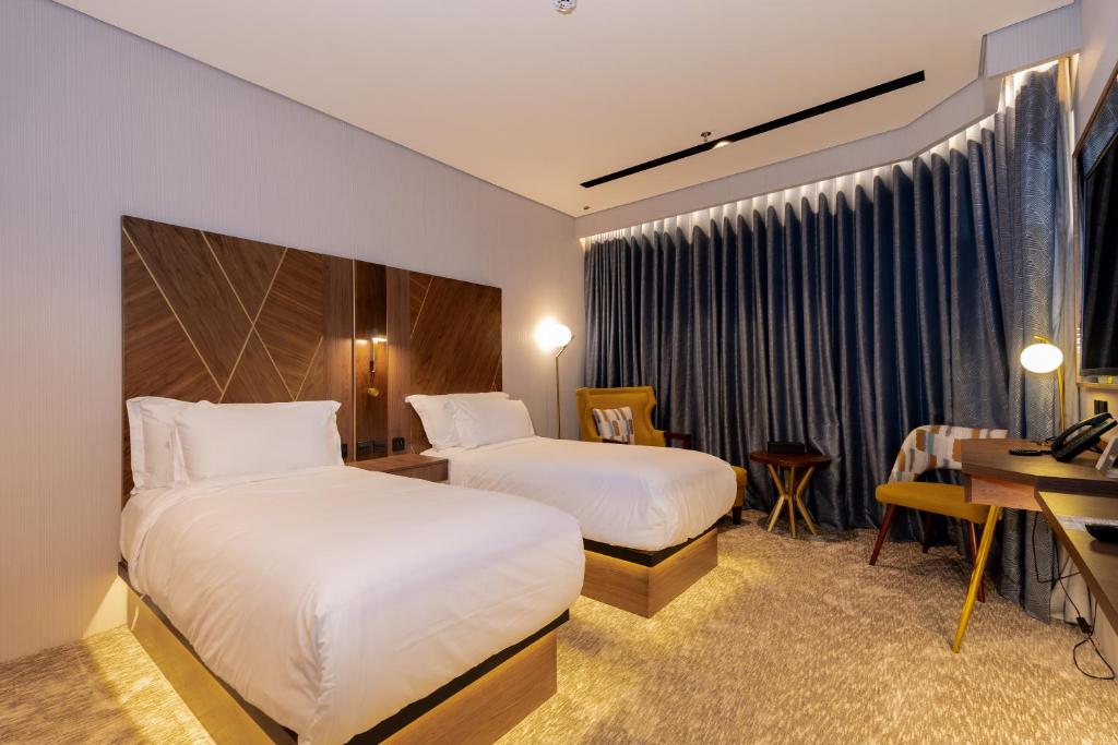 Postel nebo postele na pokoji v ubytování Damask Hotels