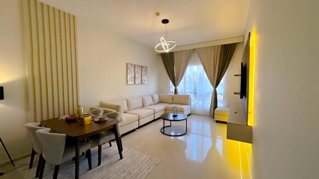 a living room with a white couch and a table at Luxury, One bedroom apartment Ocean view in Ras al Khaimah