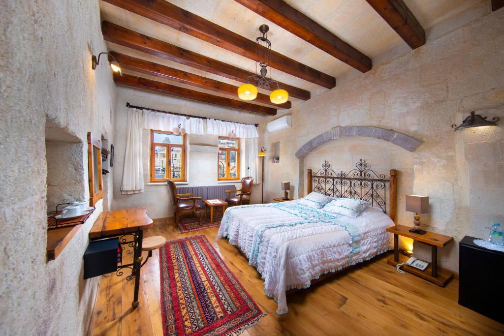 Postel nebo postele na pokoji v ubytování Terra Cave Hotel