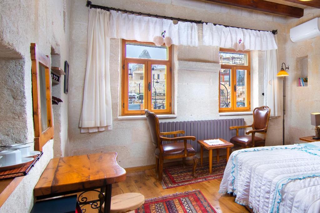 Postel nebo postele na pokoji v ubytování Terra Cave Hotel