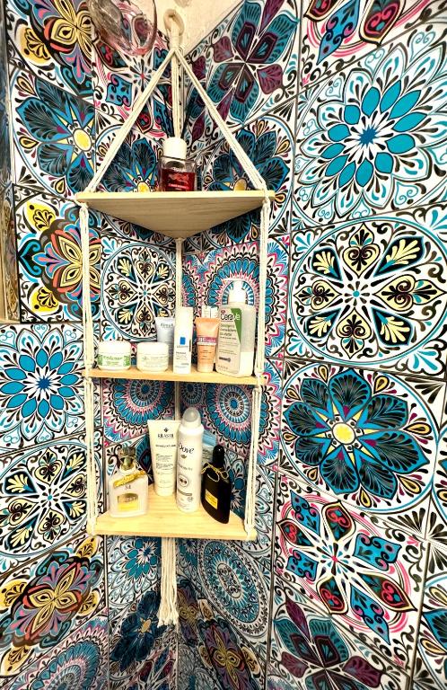 a room with a wall with a bunch of products on shelves at Relax House in Bari