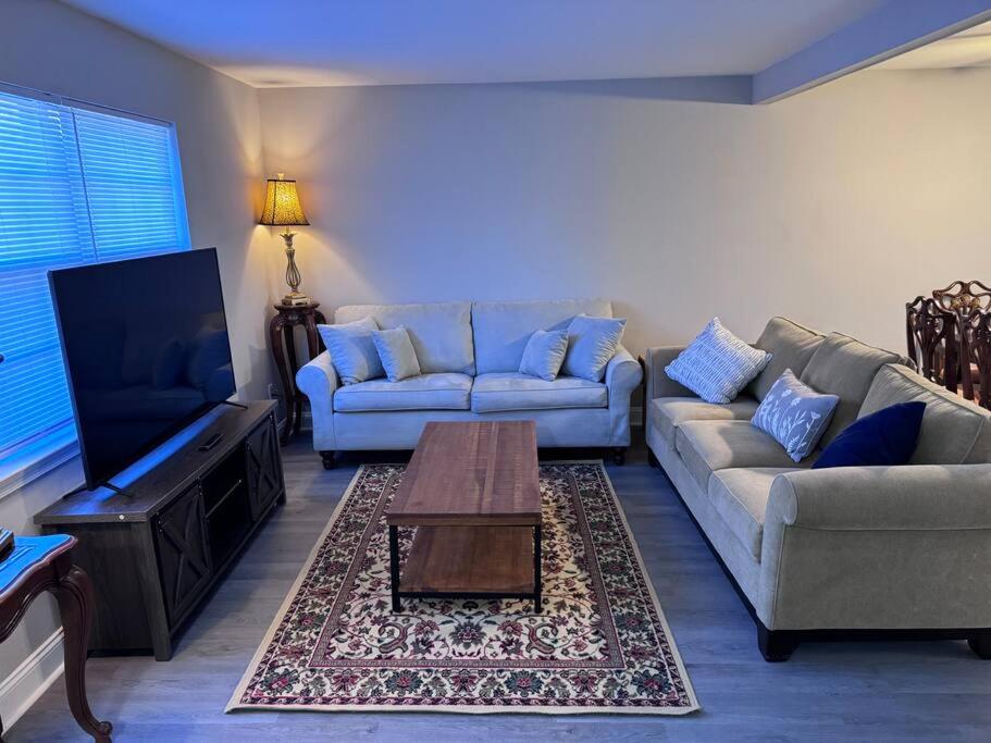 a living room with a couch and a coffee table at 3 bedroom Town home in Charlotte