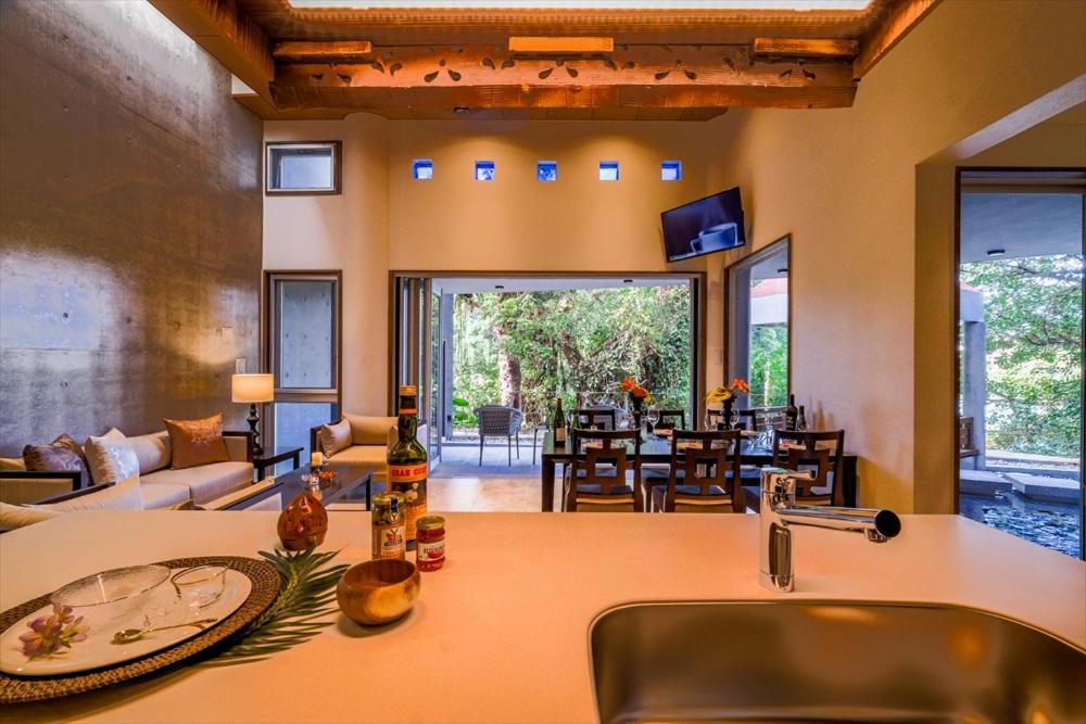 a kitchen with a sink and a living room at RIVERSIDE TERRACE OKINAWA KADENA in Kadena
