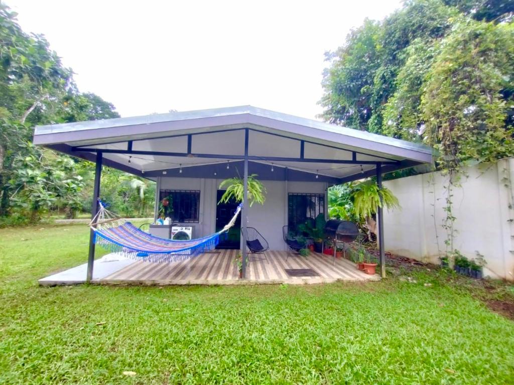 a screened in porch with a hammock on a deck at Villa bonita in Puerto Jiménez