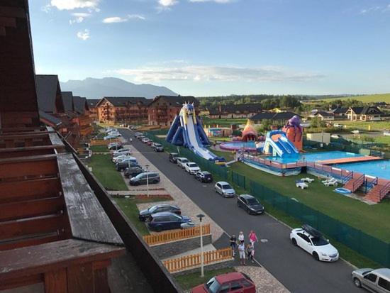 a group of cars parked in a parking lot at Tatragolf Apartment K202 in Veľká Lomnica