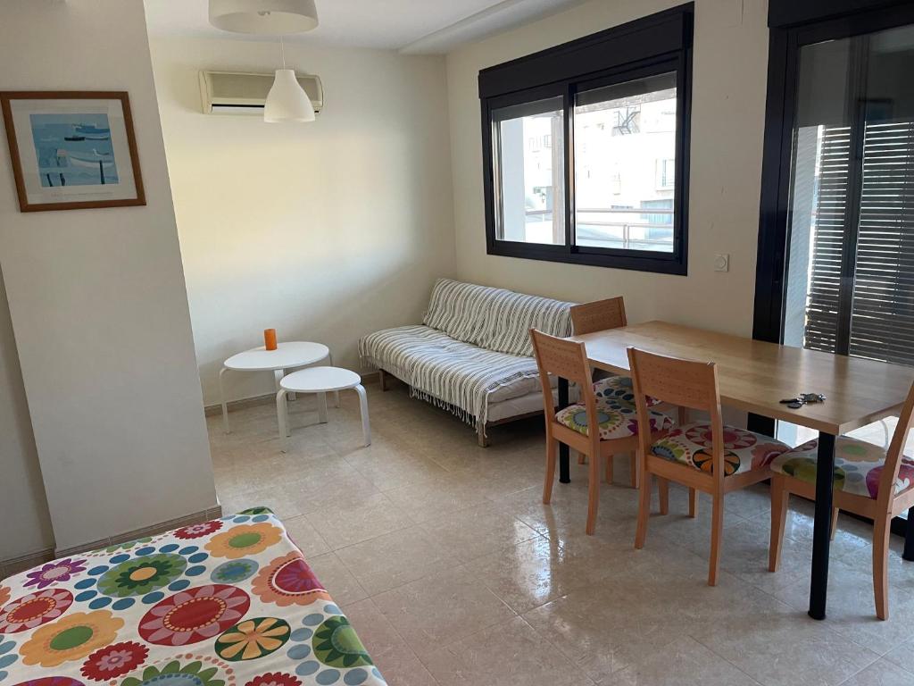 un soggiorno con tavolo e divano di Coqueto ático con vistas al mar a Carboneras